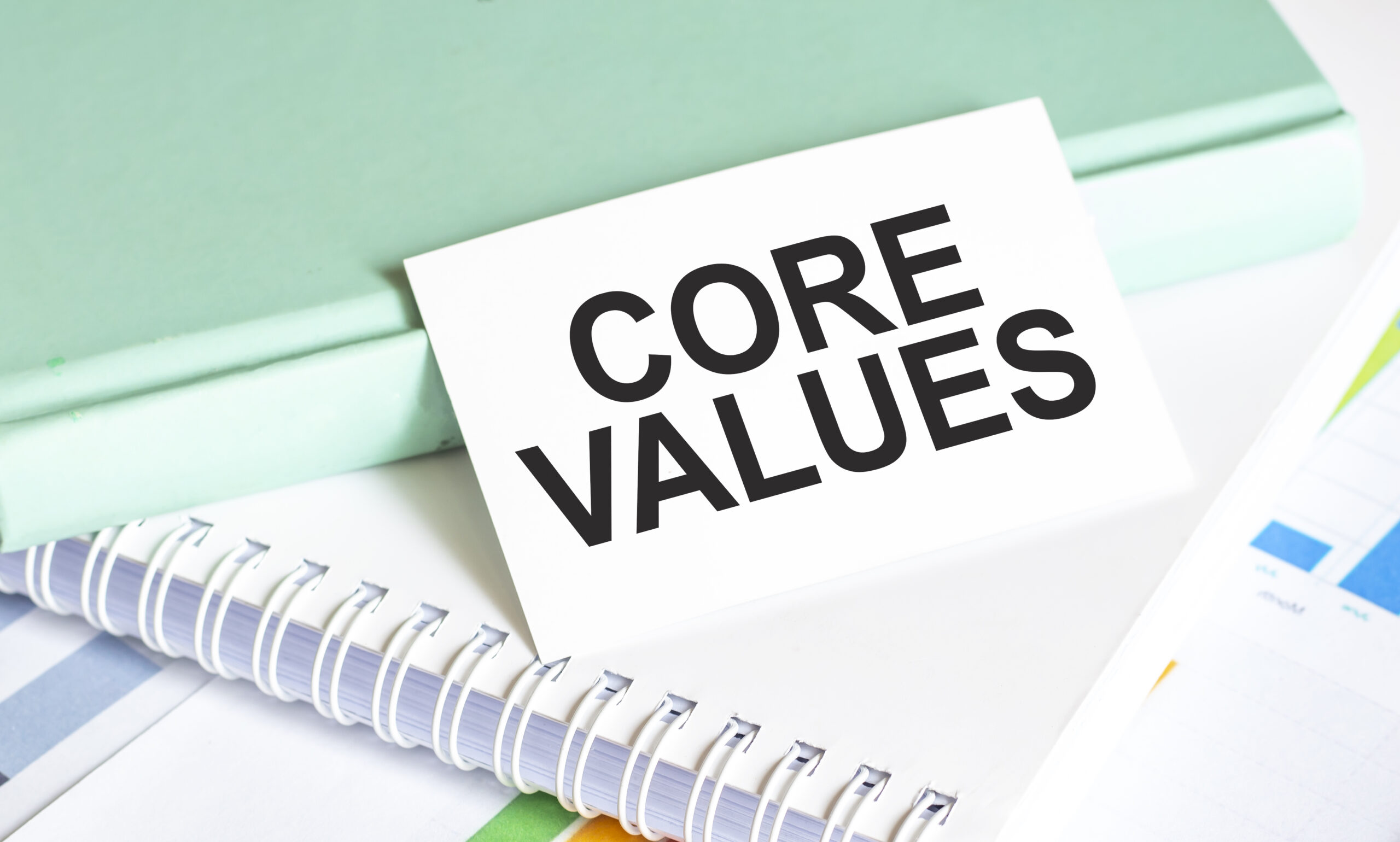 Core Values words on notepad and charts